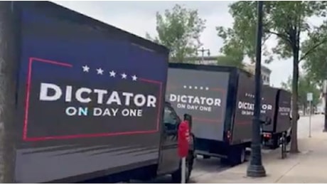 La fila di furgoni con la scritta «dittatore il primo giorno» davanti alla Convention dei Repubblicani
